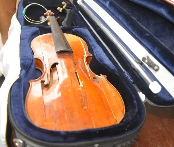 a violin broken in a case not satravi certified
